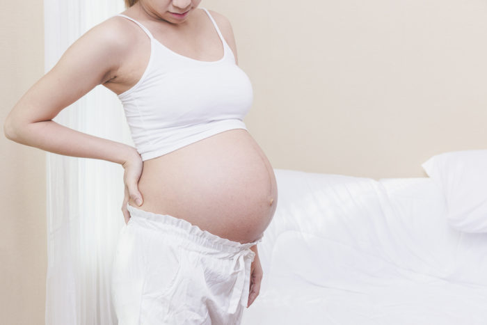 nugaros skausmas nėštumo metu naudojant šildymo padėklą